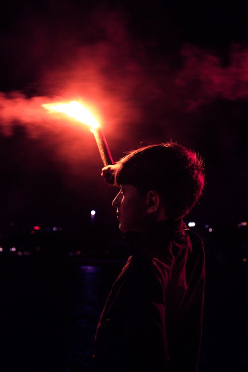 Boy holding a Red Flare