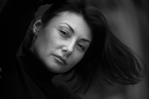 Grayscale Photo of a Woman in Turtleneck Sweater