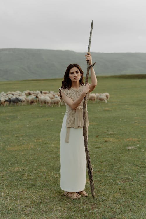 A Female Model Standing at Green Field While Posing Beautifully