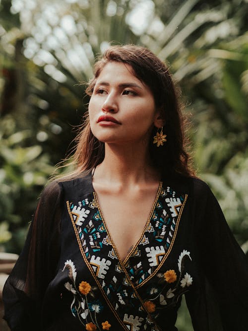 Portrait of Woman With Green Plants Behind