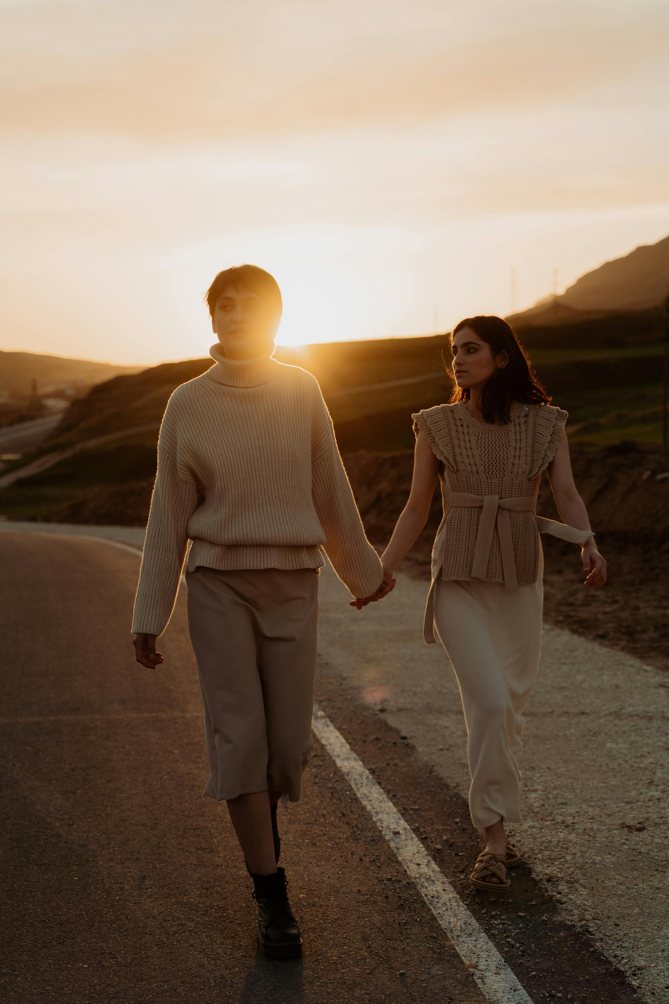 two people walking away holding hands