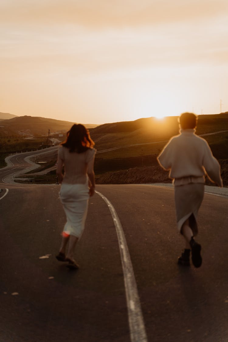 Back View Of People Running On The Road