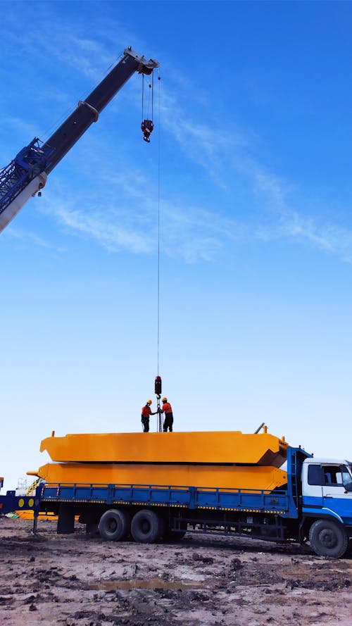 Crane Machinery Loading on a Truck, on a Construction Site