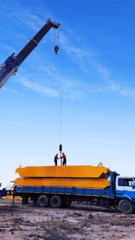 Workers operate a crane at an industrial site in Kalimantan Selatan, Indonesia