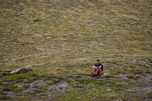 Man Relaxing at Meadow in Mountains