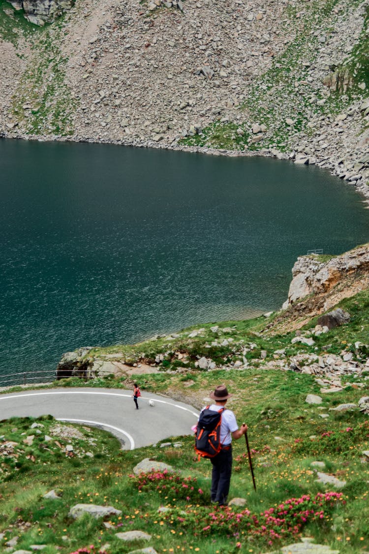 Hiker By Lake In Summer