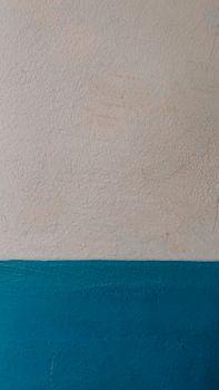 Close-up of a two-tone textured wall with blue and beige for a minimalist look.