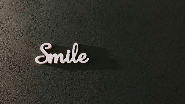 A minimalist wall with a decorative 'Smile' sign casting a shadow.