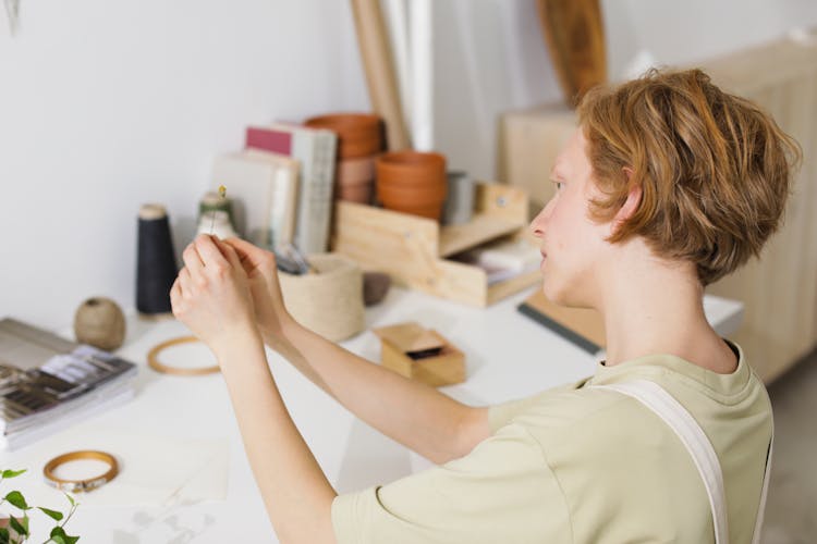 Person Holding A Sewing Needle