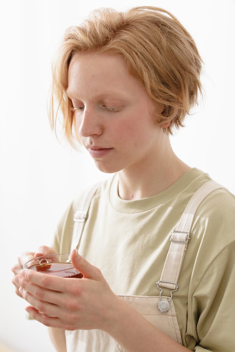 A Young Woman Holding A Cup Of Tea