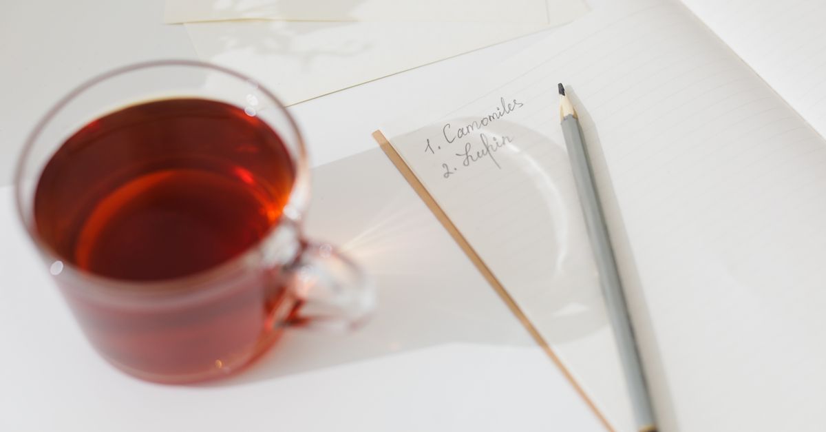 close up of handwritten journal with gratitude list and a cup of tea