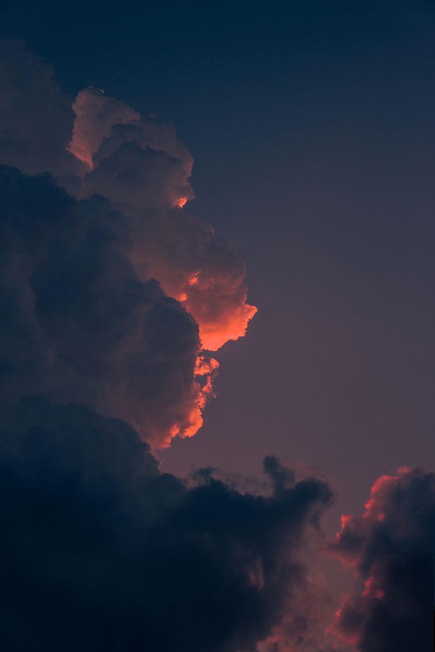 Stunning clouds glowing with sunset hues against a deep twilight sky.