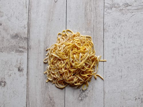 Flat Lay Shot of Pasta on Wooden Table