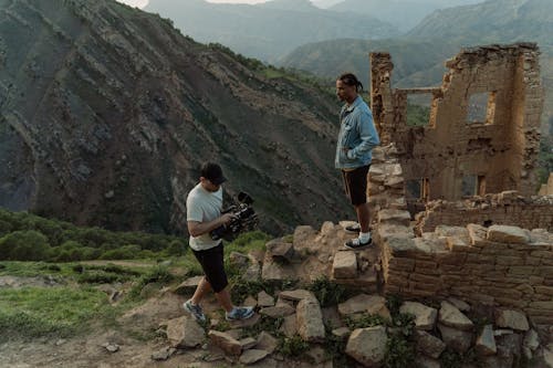 Camera Man and an Actor standing in Ruins 