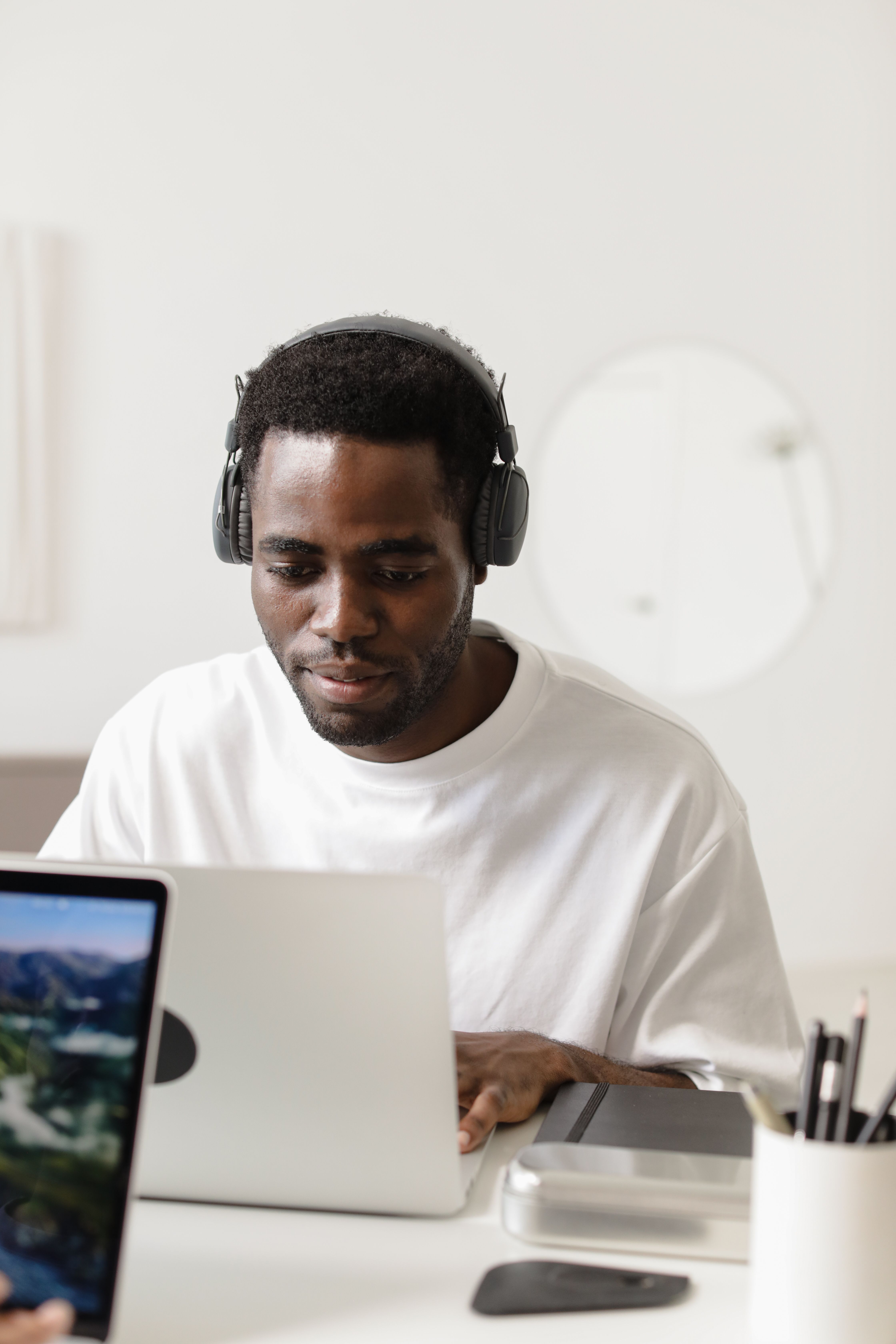 Man in white shirt using laptop - professional virtual assistant