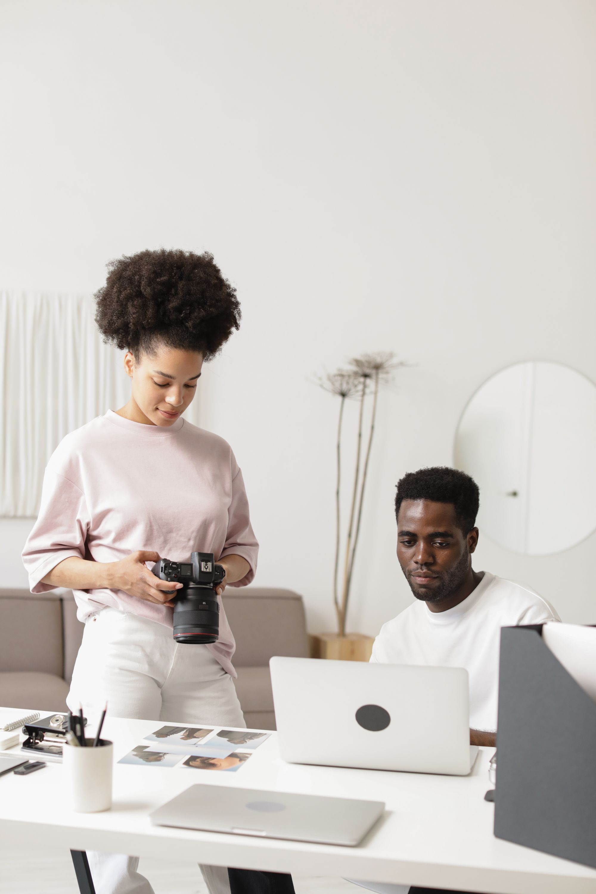 Two colleagues working together in a bright studio