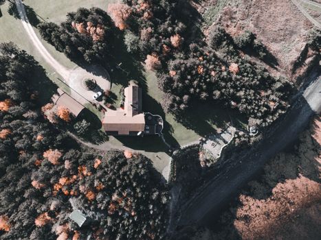 A scenic aerial shot showcasing a countryside estate surrounded by autumn foliage.