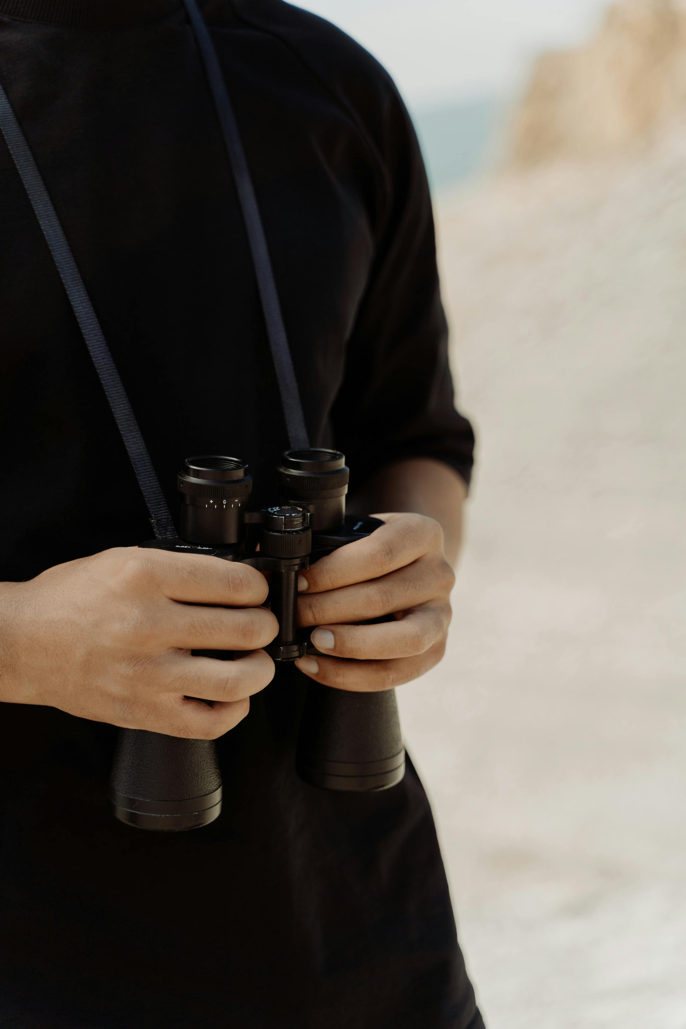 man holding binoculars