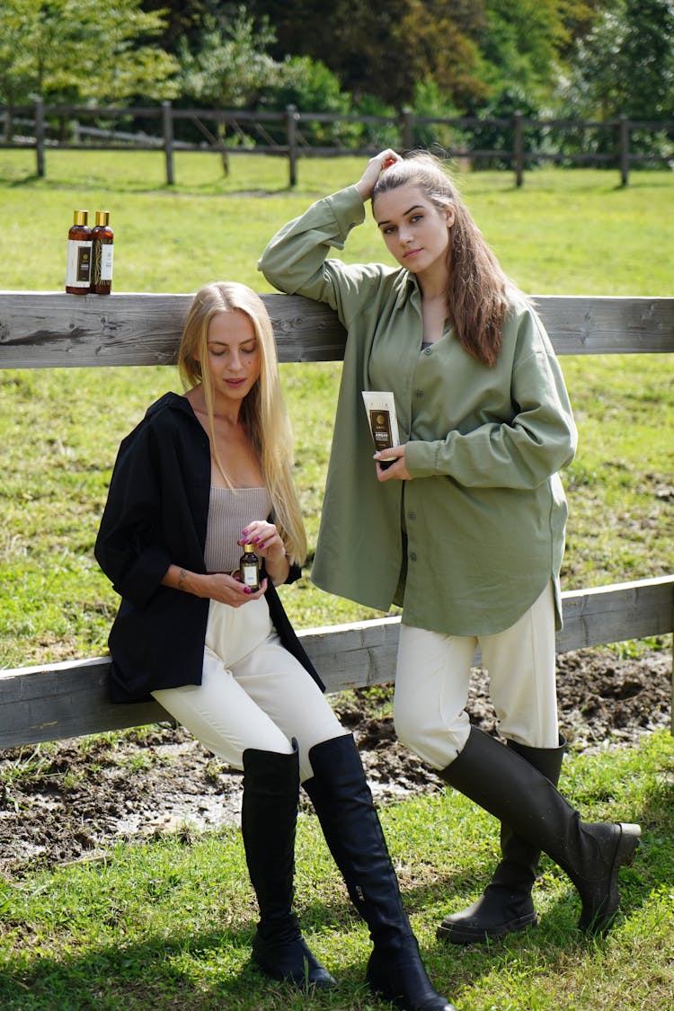 Beautiful Women On A Wooden Fence Posing With Beauty Products