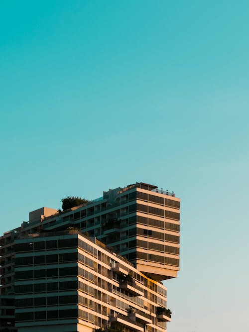 Apartment Buildings Stacked Upon Each Other Under Blue Sky