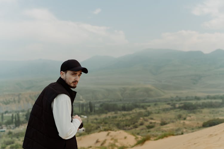 Man In Black Vest Looking Back