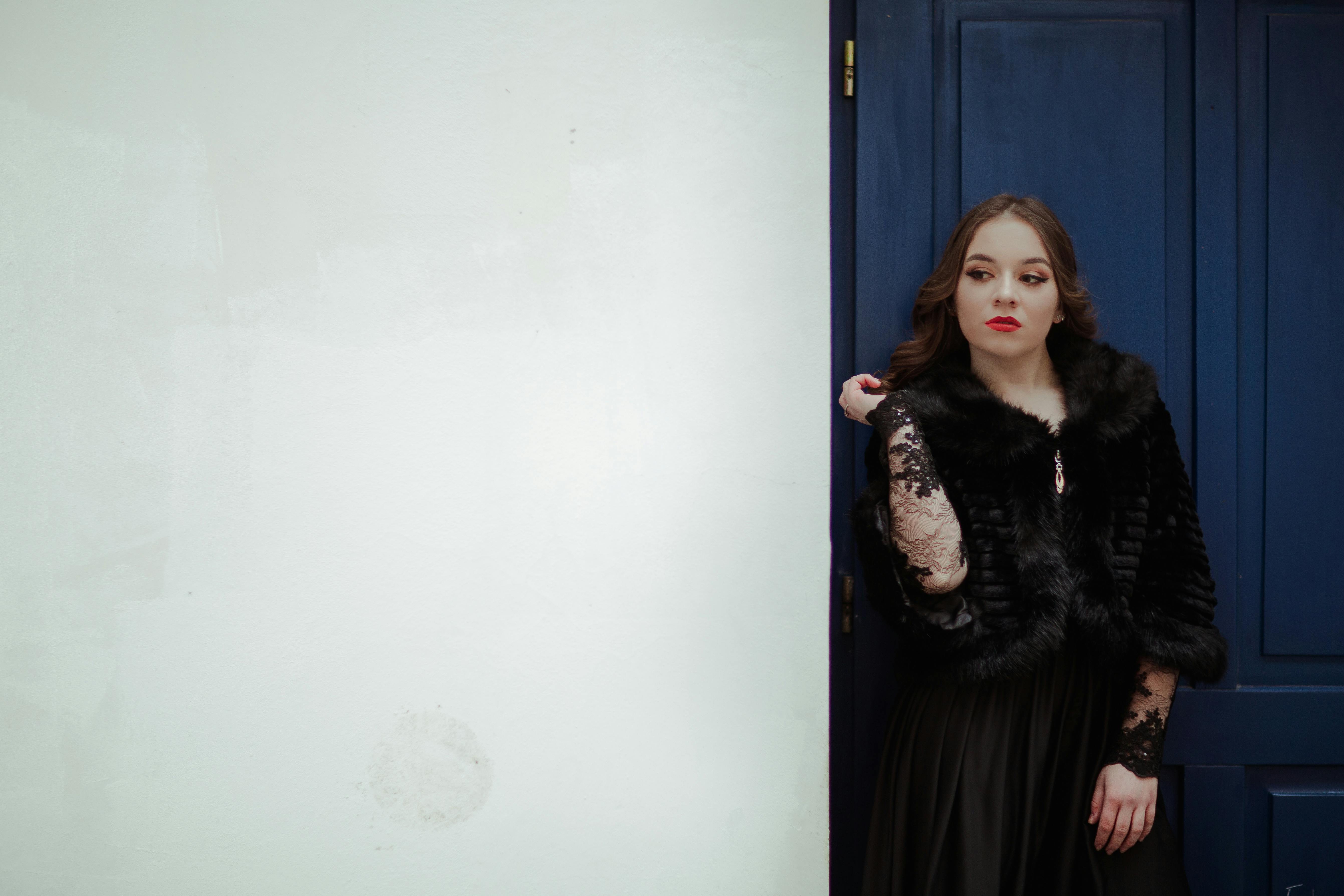 Kostenlos Frau, Die Sich Auf Blaue Tür Stützt Stock-Foto