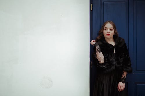 Woman Leaning on Blue Door