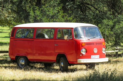 Free Red Volkswagen Kombi on Grass Field Stock Photo