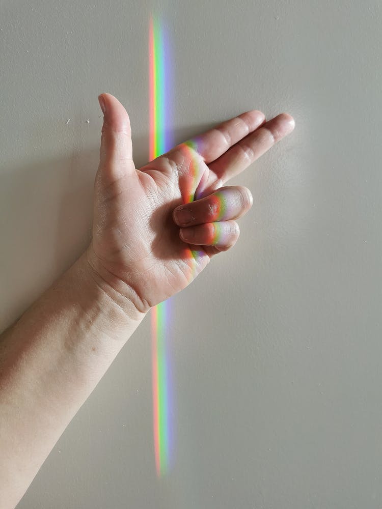 Person's Hand With Rainbow Light 