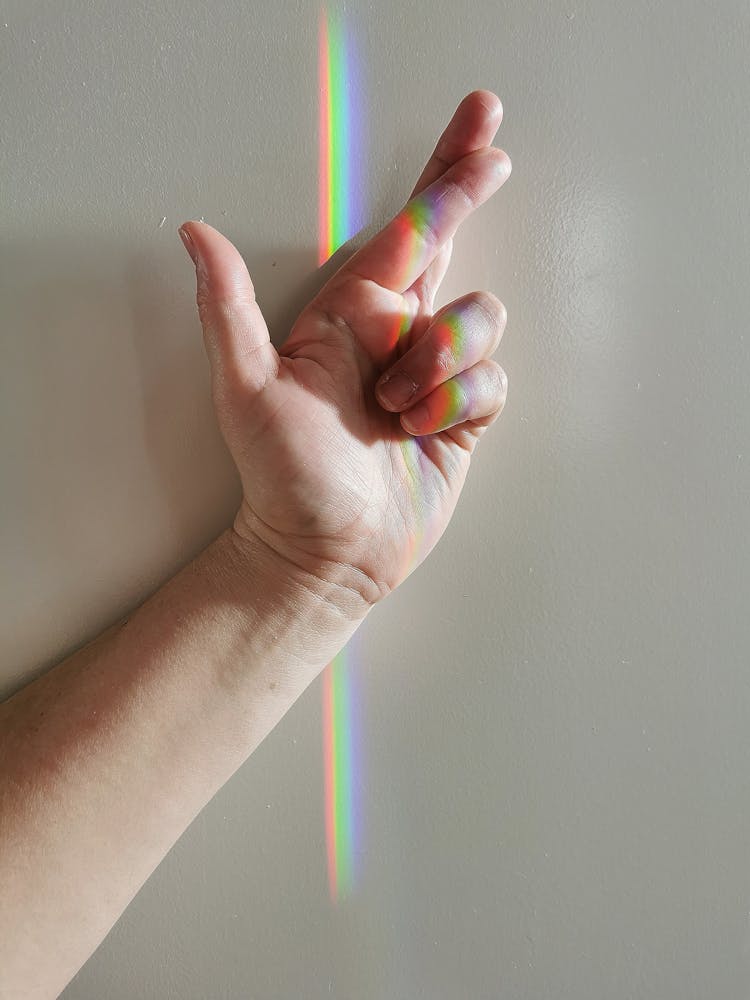 Rainbow Light On Gesturing Hand