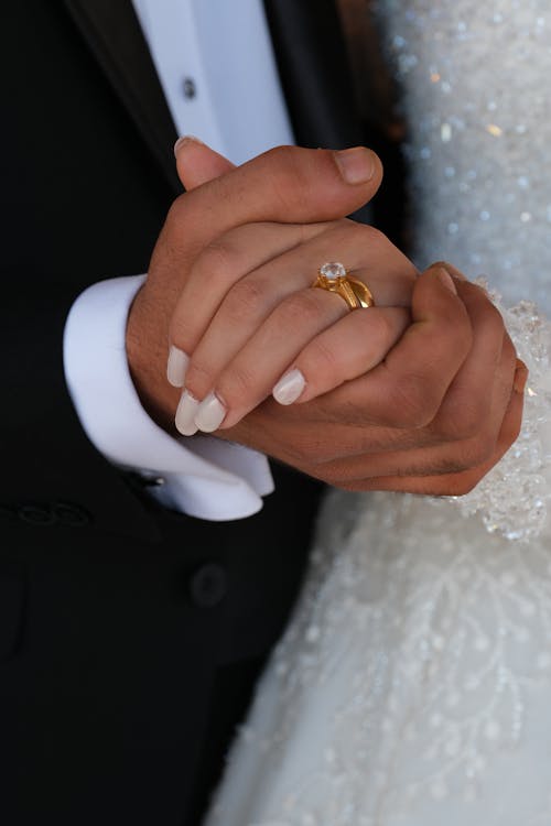 Close-Up View of Bride and Groom Holding Hands