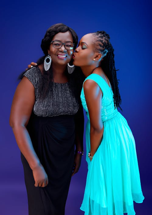 A Daughter Kissing Her Mother while Standing on a Studio