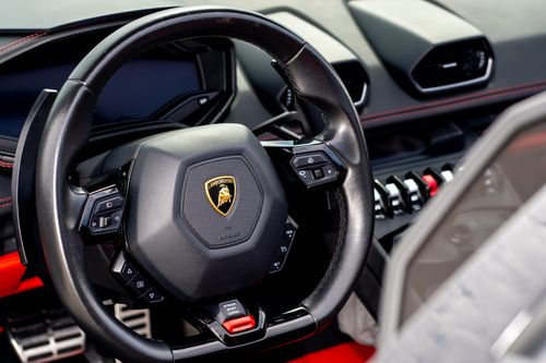 Free Intricate close-up view of a Lamborghini steering wheel showcasing luxury car design. Stock Photo