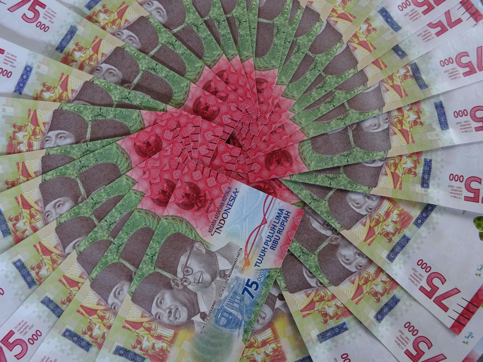 Stunning arrangement of 75,000 Indonesian Rupiah notes showcasing vibrant colors and intricate designs.