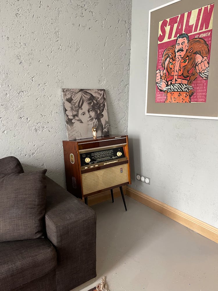 Vintage Radio Beside A Poster On A Wall