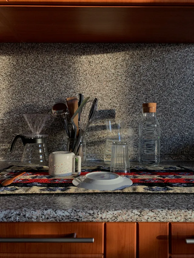 Organized kitchen counter with glassware and cooking tools