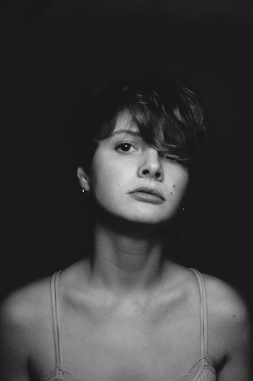 A Headshot of Female Looking at Camera in Black And White 