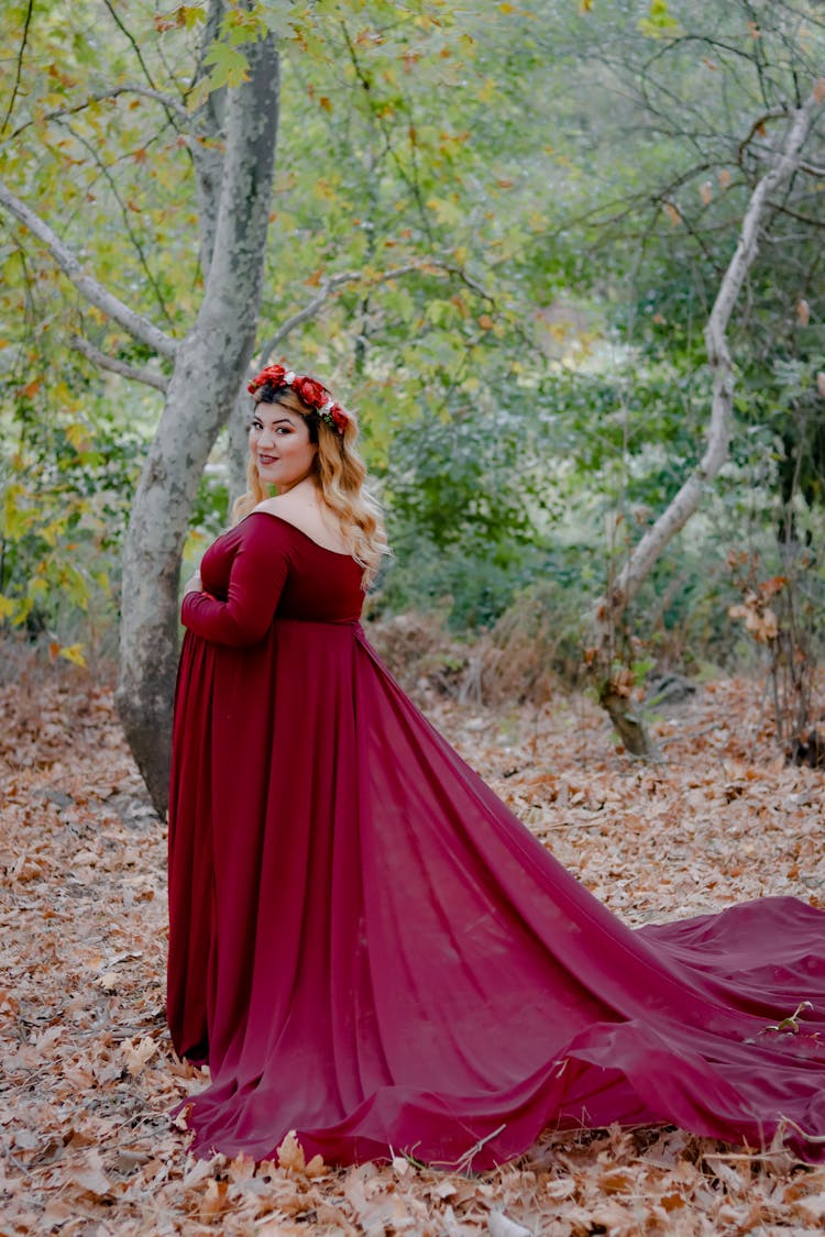 Plus Sized Woman In Red Dress In Forest