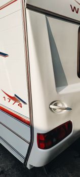 Close-up of a modern travel trailer's rear with artistic design, great for adventure travel themes.