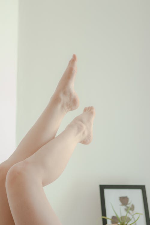 Free Person Feet on White Wall Stock Photo
