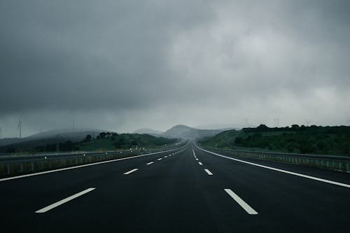 Free Empty Highway Near Mountains Stock Photo