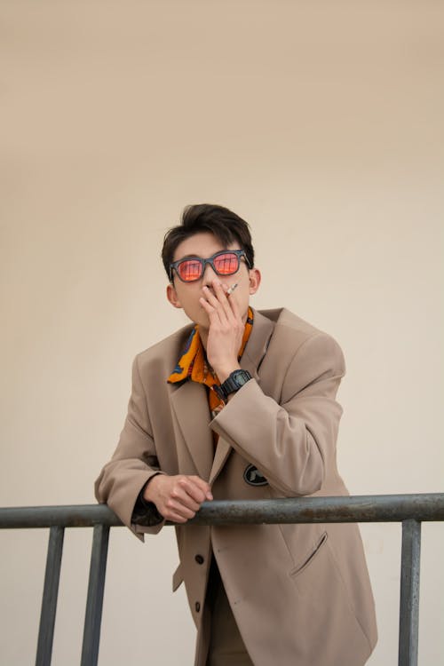 Man in Brown Coat Smoking Cigarette