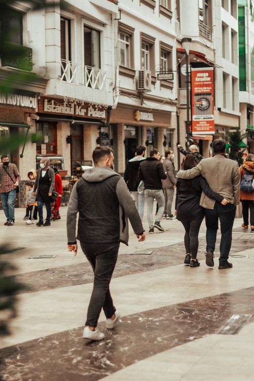 Free Lively downtown street with people walking and exploring shops. Stock Photo