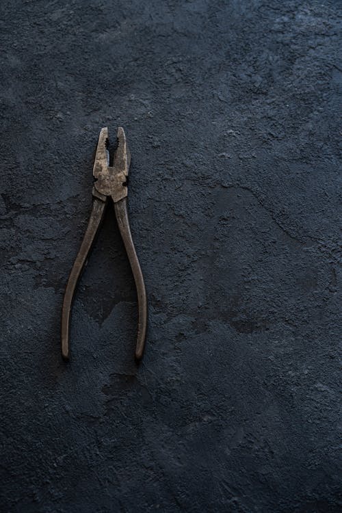 Rusty Pliers on Rough Surface