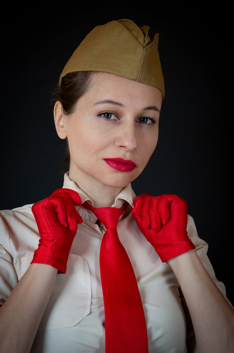 Woman Wearing Red Gloves Holding The Collar Of Her Shirt 