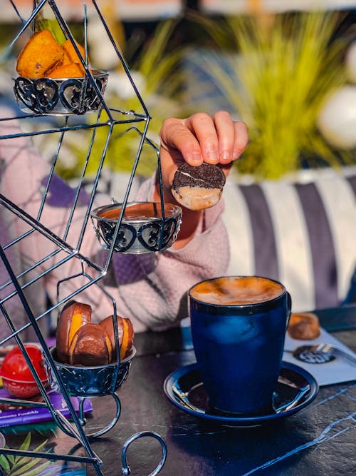 Person Holding a Round Chocolate Biscuit 