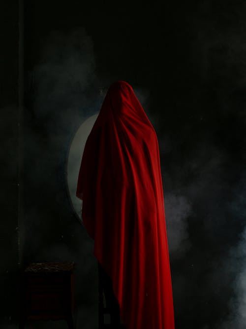 Studio Shot of Person Covered in Red Fabric