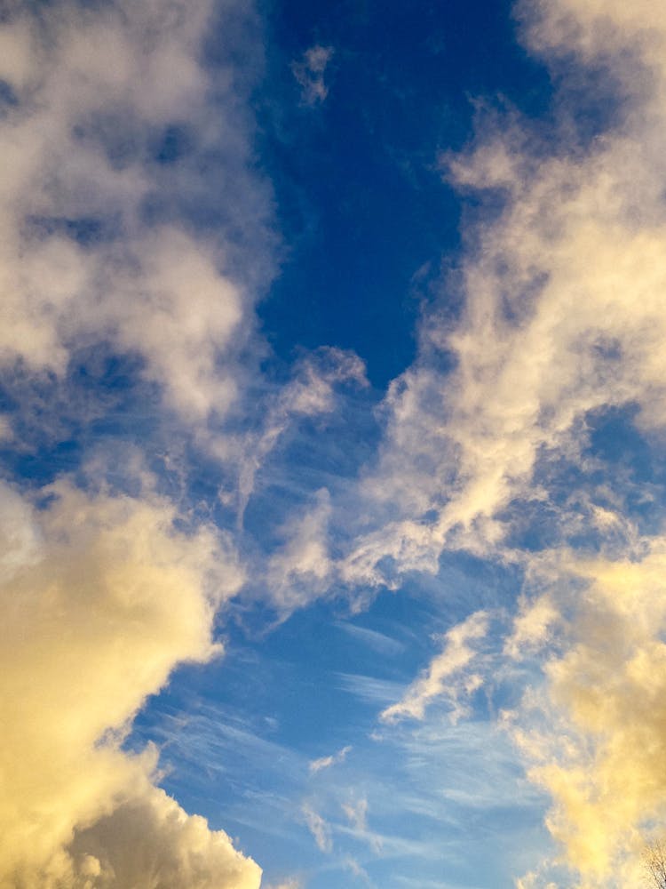 Fluffy White Clouds In Blue Sky