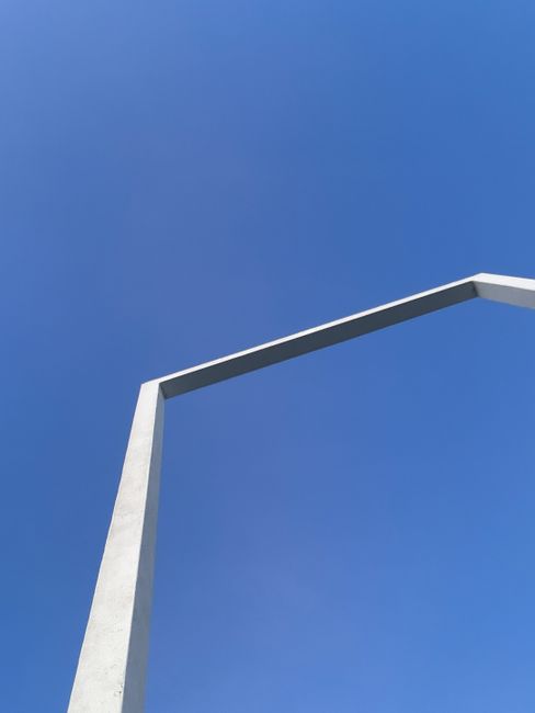 Simple concrete frame contrasting against a clear blue sky.