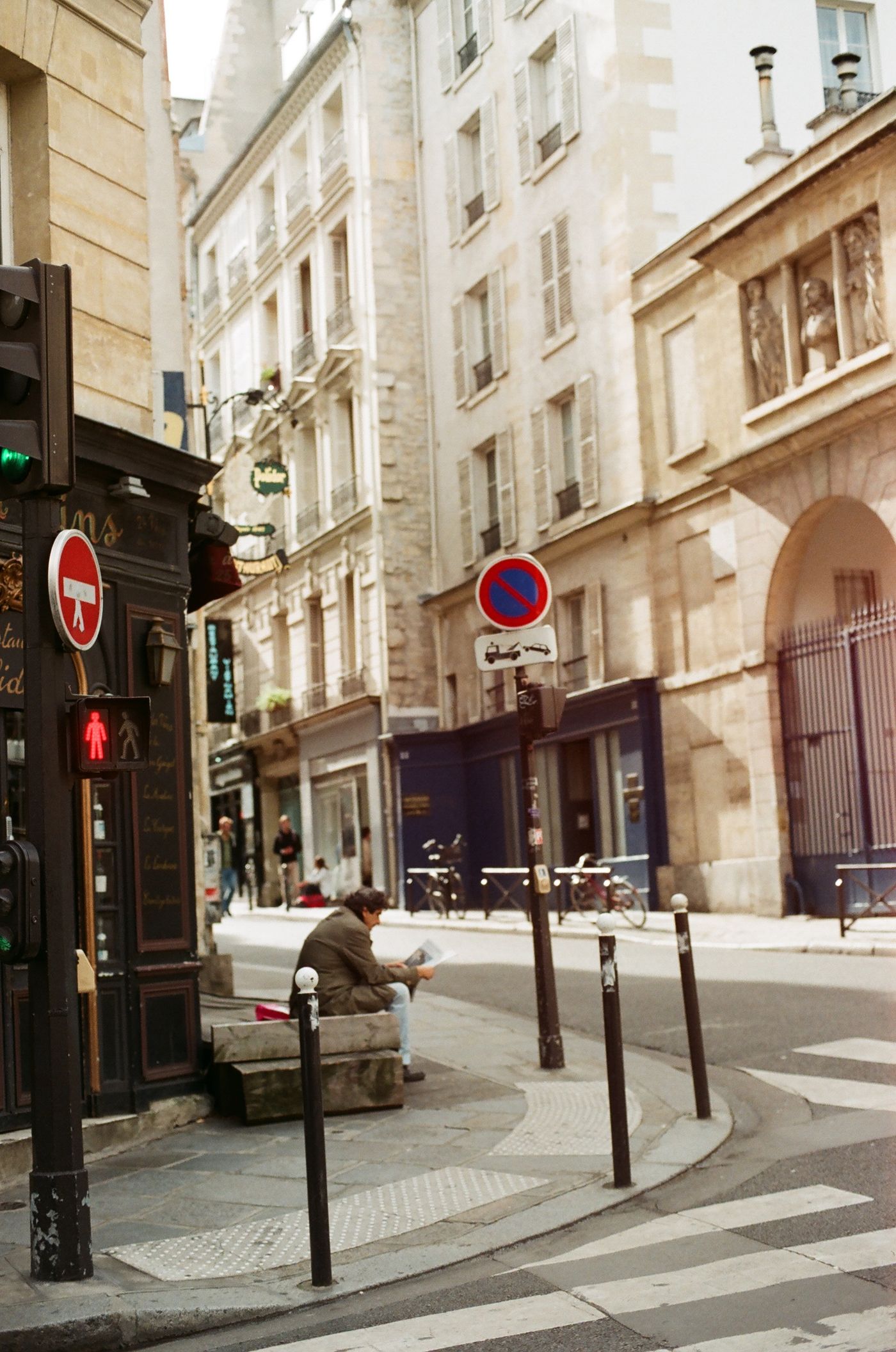 Homme lisant le journal dans une rue de Paris